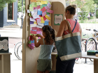 kid posting a sticky note